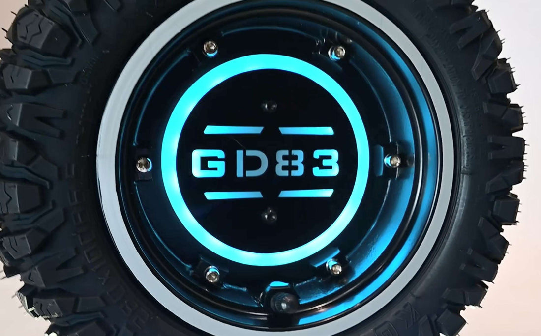 Close-up shot of a mechanic easily replacing the 11-inch off-road tire on the single-sided swing arm of a black GLIDEZONE GD83 heavy-duty electric scooter without removing the hub motor.