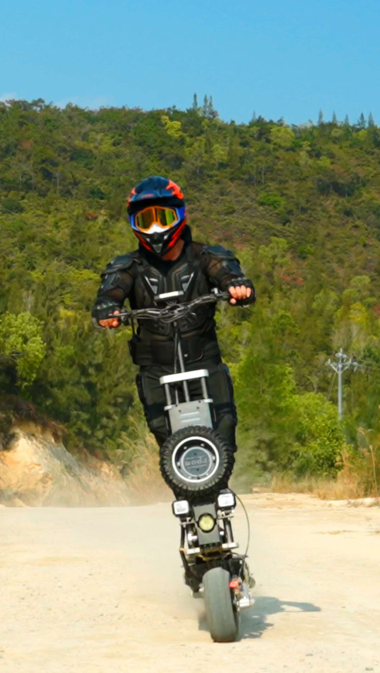 Front dynamic shot of an adult male rider wearing a helmet riding Glidezone GD83 on a sandy road.