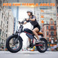Adult woman riding a fat tire electric bike to demonstrate the frame size and fit.