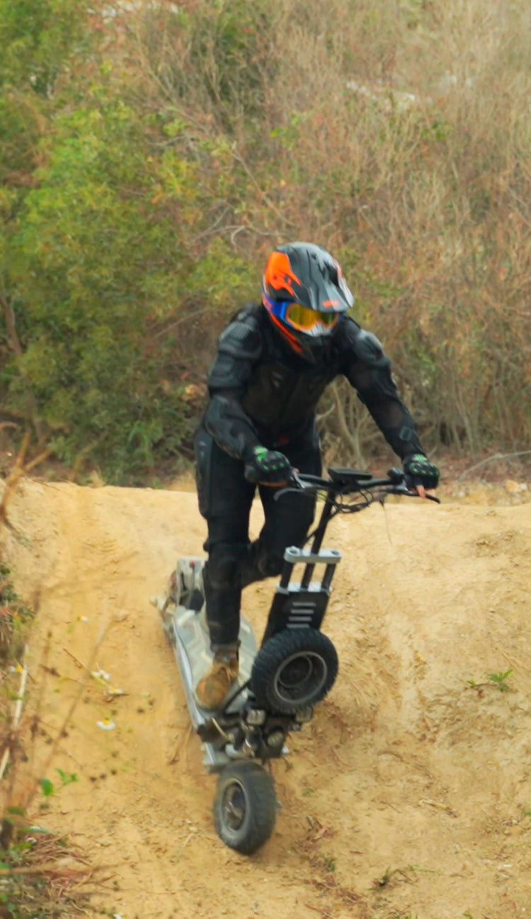 Close-up of an adult rider confidently descending a steep hill, showcasing Glidezone GD83&