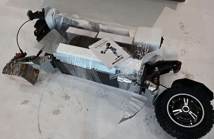 Real unboxing photo of Glidezone GD83 adult electric scooter showing packaged accessories and folded frame.