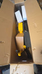 An open cardboard shipping box showing the interior protective foam packaging and components of a yellow wholesale used electric bike inside a US warehouse.
